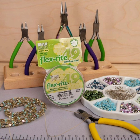 <p>Профессиональный ювелирный тросик Flex-Rite с нейлоновым покрытием. 49-жильный тросик премиум-класса. Цвет золотой, матовый. Оттенок может немного отличаться от фотографии и в разных поставках. Цена за катушку 30 футов (9.1 метра).</p>