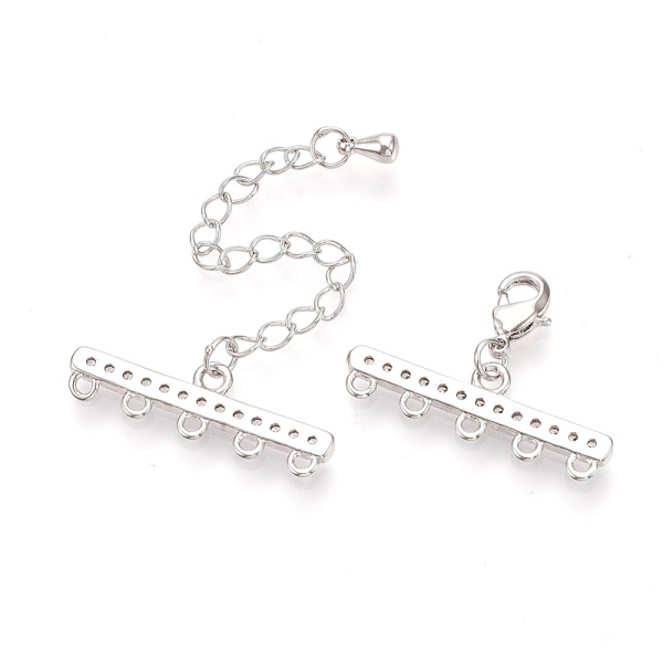 <p>Элитная ювелирная фурнитура премиум класса - Милано люкс (Milano Lux), качественный элемент для создания бижутерии. Набор для окончания многорядного украшения или широкого плетёного браслета/колье. В набор входят 2 соединителя-переходника с 5 на 1 нить размером 28*8 мм, инкрустированных кристально-прозрачными стразами - фианитами (Cubic Zirconia – кубик циркония, CZ, цирконы). К одному концевику прикреплена застежка карабин (лобстер), к другому - цепочка-удлинитель длиной около 5 см. и декоративной капелькой на конце. В застёгнутом виде длина концевиком вместе с замочком (без учёта удлинителя) составляет около 28 мм. Цвет под родий. Оттенок может отличаться от фотографии и в разных поставках. При желании концевики можно отсоединить и использовать как коннекторы или подвески. Цена за 1 набор.</p>