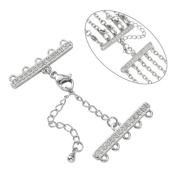 <p>Элитная ювелирная фурнитура премиум класса - Милано люкс (Milano Lux), качественный элемент для создания бижутерии. Набор для окончания многорядного украшения или широкого плетёного браслета/колье. В набор входят 2 соединителя-переходника с 5 на 1 нить размером 28*8 мм, инкрустированных кристально-прозрачными стразами - фианитами (Cubic Zirconia – кубик циркония, CZ, цирконы). К одному концевику прикреплена застежка карабин (лобстер), к другому - цепочка-удлинитель длиной около 5 см. и декоративной капелькой на конце. В застёгнутом виде длина концевиком вместе с замочком (без учёта удлинителя) составляет около 28 мм. Цвет под родий. Оттенок может отличаться от фотографии и в разных поставках. При желании концевики можно отсоединить и использовать как коннекторы или подвески. Цена за 1 набор.</p>