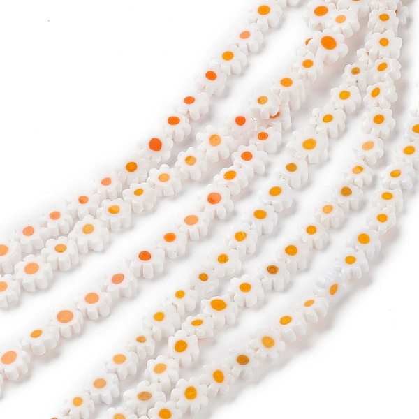 <p>Стеклянные бусины - цветочки ручной работы, выполнены в технике миллефиори (миллефьори). Бусины белого цвета с жёлтой серединкой, напоминают ромашки. У некоторых бусин не хватает лепестков. Оттенок может отличаться от фотографии и от партии к партии. Бусины могут существенно отличаться по форме и размеру. У бусин могут быть скошены лепестки. В низке около 26 бусин, низки формируются без проверки каждой бусины на дефекты. Цена за низку.
</p>
