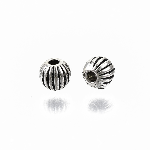 <p>
Бусина - разделитель шарик с полосками, стиль тибетское серебро. Оттенок может отличаться от фотографии. Диаметр отверстия около 1 мм. Бусины литые, довольно тяжелые. Цена за упаковку 10 грамм (около 60 бусин).
</p>